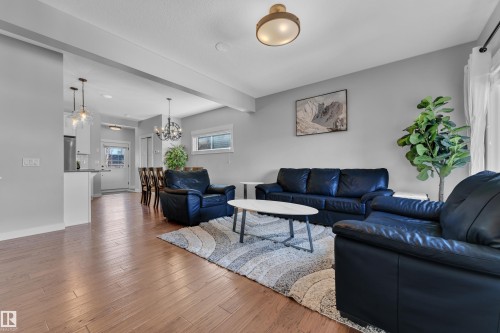 The living area features hardwood floors and light gray walls - 6406 169 Avenue, Edmonton, AB - Indoor Photo Showing Living Room
