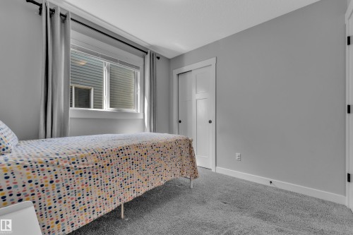 The property features a room with light grey walls, a window with horizontal blinds, and a carpeted floor - 6406 169 Avenue, Edmonton, AB - Indoor Photo Showing Bedroom