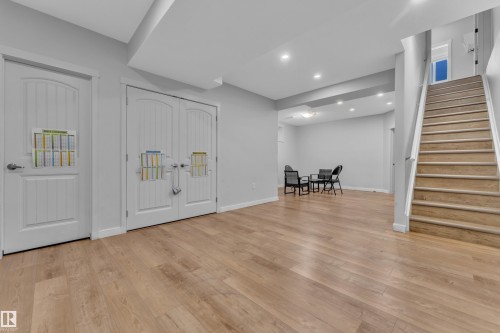 The property features light wood flooring, light grey walls, and recessed lighting - 6406 169 Avenue, Edmonton, AB - Indoor Photo Showing Other Room