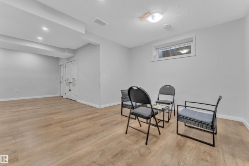 Spacious room featuring light-toned flooring, light grey walls, and a window providing natural light - 6406 169 Avenue, Edmonton, AB - Indoor