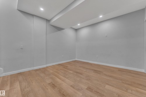 Versatile room featuring light grey walls, recessed ceiling lighting, and wood-style flooring - 6406 169 Avenue, Edmonton, AB - Indoor Photo Showing Other Room