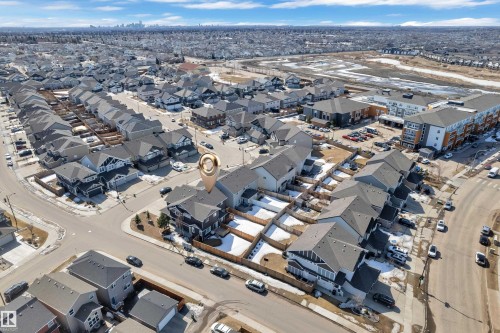 Aerial view of the property and its surrounding neighborhood, featuring residential streets, detached homes, and multi-story buildings, all under a clear sky - 6406 169 Avenue, Edmonton, AB - Outdoor With View