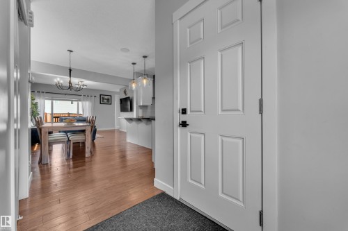 Entryway with hardwood flooring throughout leading into the dining and living spaces - 6406 169 Avenue, Edmonton, AB - Indoor Photo Showing Other Room