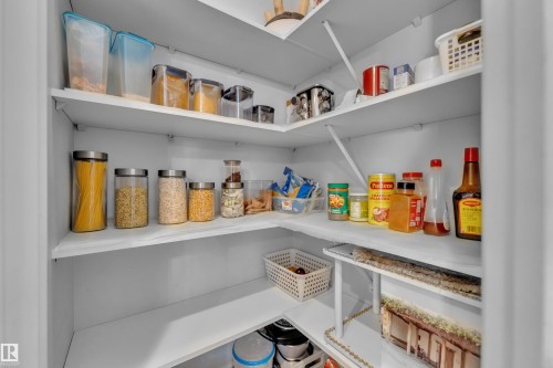 This pantry offers extensive storage with white shelving and built-in corner shelves - 6406 169 Avenue, Edmonton, AB - Indoor