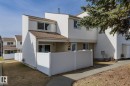 The property features a multi-story exterior with white siding and a brown roof - 37 Woodvale Village, Edmonton, AB  - Outdoor 
