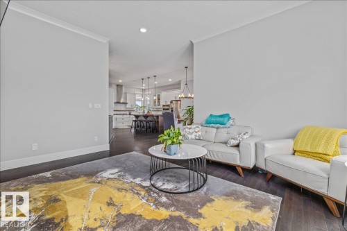 The property features dark wood flooring, light grey walls, and recessed lighting - 3908 Ginsburg Crescent, Edmonton, AB - Indoor Photo Showing Living Room