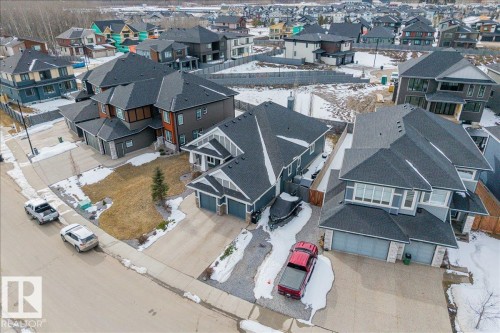 Aerial view showcasing the property with a dark-toned roof and a driveway leading to a garage - 3908 Ginsburg Crescent, Edmonton, AB - Outdoor