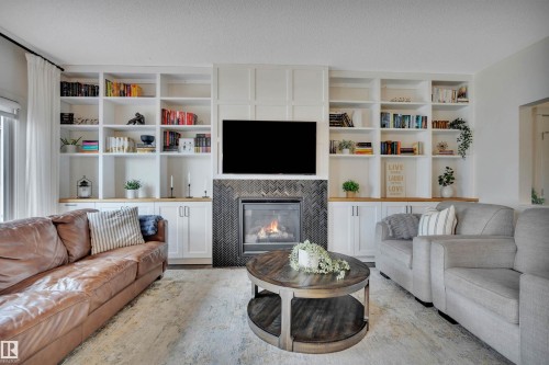 8945 24 Avenue, Edmonton, AB - Indoor Photo Showing Living Room With Fireplace