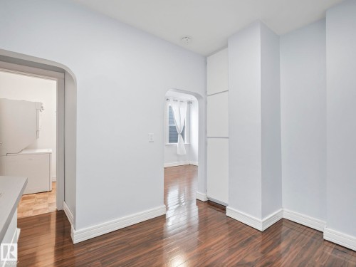 The property features wood flooring, white walls, and white baseboards - 12141 96 Street, Edmonton, AB - Indoor Photo Showing Other Room