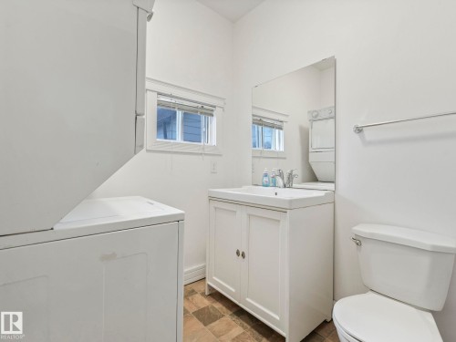 Bathroom with white walls, a white vanity with a rectangular sink, a toilet, and a window - 12141 96 Street, Edmonton, AB - Indoor Photo Showing Laundry Room