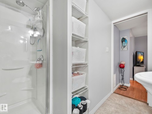 Bathroom featuring a shower stall with clear glass enclosure and a built-in shelf system - 12141 96 Street, Edmonton, AB - Indoor Photo Showing Bathroom
