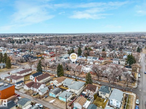Aerial view of the surrounding neighborhood, featuring residential properties with various architectural styles and mature trees - 12141 96 Street, Edmonton, AB - Outdoor With View