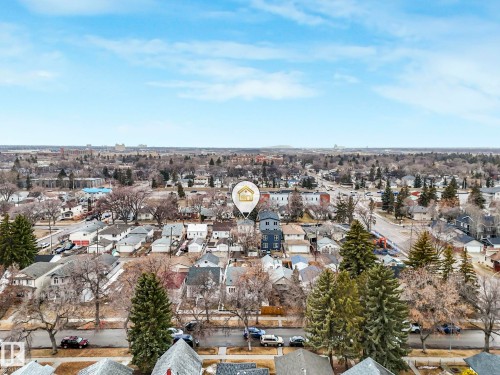 An aerial view of the property and its surrounding neighborhood, showcasing streets, numerous other properties, and mature trees - 12141 96 Street, Edmonton, AB - Outdoor With View