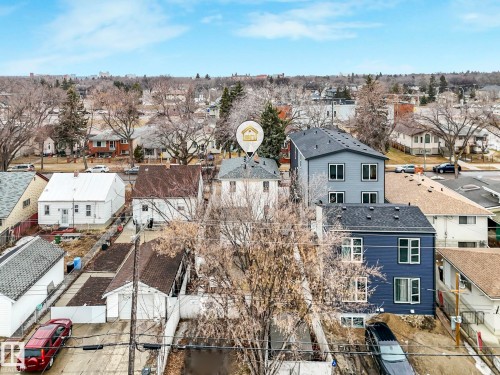 Aerial perspective showcasing the property's location within a residential neighborhood featuring established trees - 12141 96 Street, Edmonton, AB - Outdoor