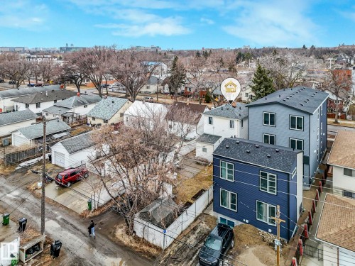 Aerial view of the neighborhood showcasing two modern properties with dark siding and white window frames - 12141 96 Street, Edmonton, AB - Outdoor