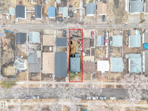 Aerial view of the property, located on a street with residences and parked vehicles - 12141 96 Street, Edmonton, AB - Other