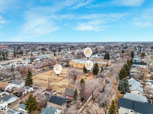 Aerial view of the neighborhood showcasing residential properties, a large open field, and institutional buildings - 12141 96 Street, Edmonton, AB - Outdoor With View