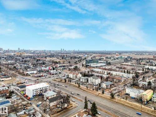 Aerial view of the surrounding neighbourhood, showcasing local roads and buildings under a clear sky - 12141 96 Street, Edmonton, AB - Outdoor With View
