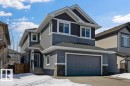 The property features a two-story exterior with multi-toned grey siding and white trim - 17534 60A Street, Edmonton, AB  - Outdoor With Facade 