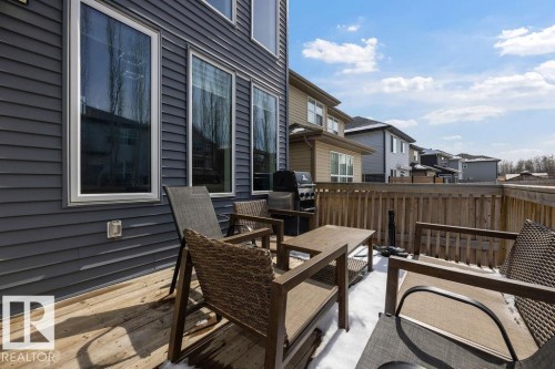 The property features a wood deck and dark siding - 17534 60A Street, Edmonton, AB - Outdoor With Deck Patio Veranda With Exterior