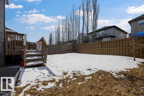 The property features a fenced backyard with a wooden deck and stairs - 17534 60A Street, Edmonton, AB - Outdoor