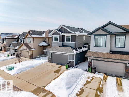 The property features a two-story design with a gray exterior and dark trim, complemented by a front-facing garage - 17534 60A Street, Edmonton, AB - Outdoor With Facade