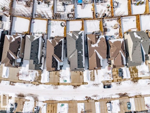 Aerial view of a residential area featuring properties with pitched roofs, individual driveways, and fenced backyards - 17534 60A Street, Edmonton, AB - Indoor Photo Showing Gym Room