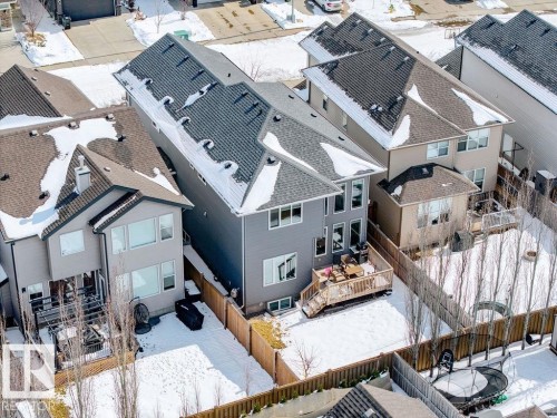 This property features a two-story design with a wooden deck and a fenced yard - 17534 60A Street, Edmonton, AB - Outdoor