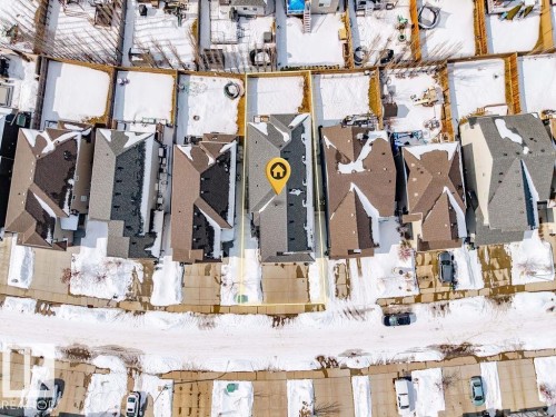 Aerial view showcasing the property's roof with gray shingles, the paved driveway, and the fenced backyard area - 17534 60A Street, Edmonton, AB - Indoor Photo Showing Gym Room