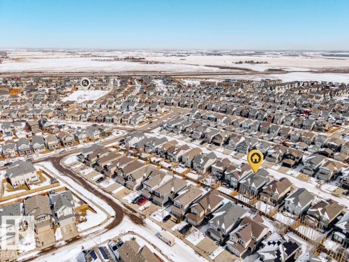 Aerial view of a residential community featuring numerous houses with various roof styles and colors, surrounded by snow-dusted ground and roads - 17534 60A Street, Edmonton, AB - Outdoor With View