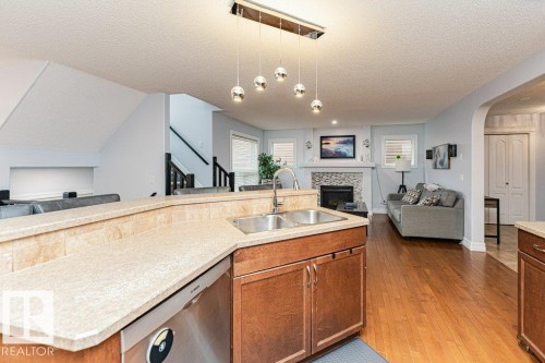 17 Cranberry Bend, Fort Saskatchewan, AB - Indoor Photo Showing Kitchen With Fireplace With Double Sink