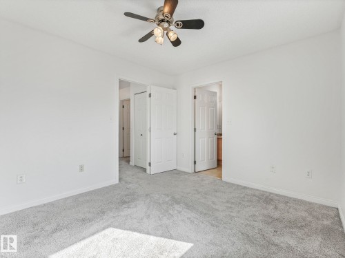This room features light grey carpeting and white walls, creating a neutral canvas - 675 Mcallister Loop, Edmonton, AB - Indoor Photo Showing Other Room