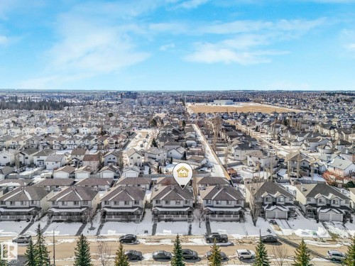 Aerial view of the property and surrounding neighborhood, featuring residential homes with grey roofs and driveways - 675 Mcallister Loop, Edmonton, AB - Outdoor With View