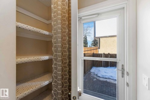 This space features built-in shelving with decorative liners, providing storage solutions - 8 14511 52 Street, Edmonton, AB - Indoor