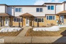 The property features a two-story exterior with white siding on the upper level and a textured yellow finish on the lower level - 8 14511 52 Street, Edmonton, AB  - Outdoor 