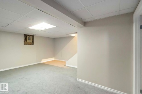 The property features light gray walls and a drop ceiling with recessed lighting - 8 14511 52 Street, Edmonton, AB - Indoor Photo Showing Other Room