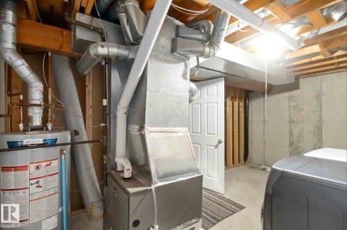 The property includes a water heater and furnace, providing essential utilities - 8 14511 52 Street, Edmonton, AB - Indoor Photo Showing Basement