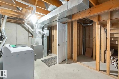The property features an unfinished basement with exposed wooden joists and concrete flooring - 8 14511 52 Street, Edmonton, AB - Indoor Photo Showing Basement