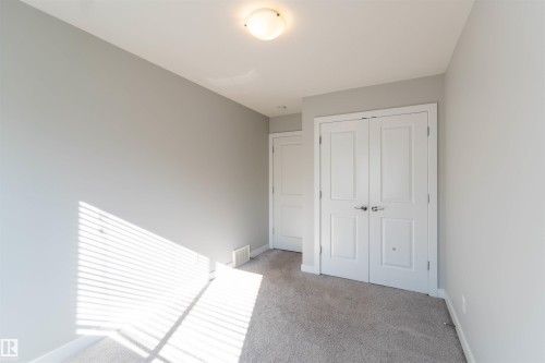 Room featuring carpeted floors, light grey walls, and white trim - 1793 Keene Crescent, Edmonton, AB - Indoor