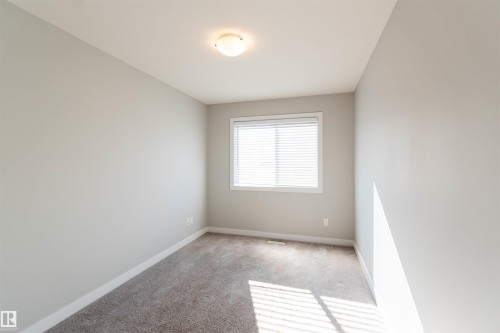 The room features light gray walls, a window with blinds, and a neutral-toned carpet - 1793 Keene Crescent, Edmonton, AB - Indoor Photo Showing Other Room