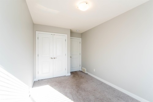 This room features light grey walls, a flush mount ceiling light, and grey carpet - 1793 Keene Crescent, Edmonton, AB - Indoor Photo Showing Other Room