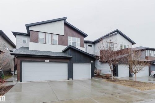 The property features a contemporary exterior with multi-toned siding, a two-car garage, and a steeply pitched roofline - 1793 Keene Crescent, Edmonton, AB - Outdoor