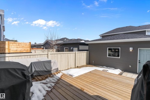 The property features an outdoor wooden deck and a privacy fence - 1305 Enright Landing, Edmonton, AB - Outdoor With Deck Patio Veranda With Exterior