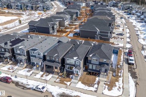 Aerial view of the residential property showcasing the roof, front yard, and driveway - 1305 Enright Landing, Edmonton, AB - Outdoor