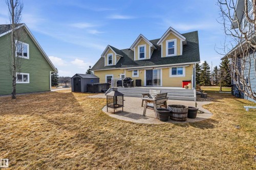 The property features a spacious deck and patio area, perfect for outdoor enjoyment - 17 Sunset Harbour, Rural Wetaskiwin County, AB - Outdoor
