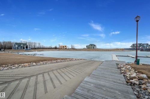 This area features a deep water boat launch and a wooden dock, providing direct access to the water - 17 Sunset Harbour, Rural Wetaskiwin County, AB - Outdoor With Body Of Water With View