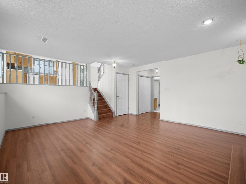 Spacious room featuring hardwood flooring, white walls, and recessed lighting - 14523 32 Street, Edmonton, AB - Indoor Photo Showing Other Room