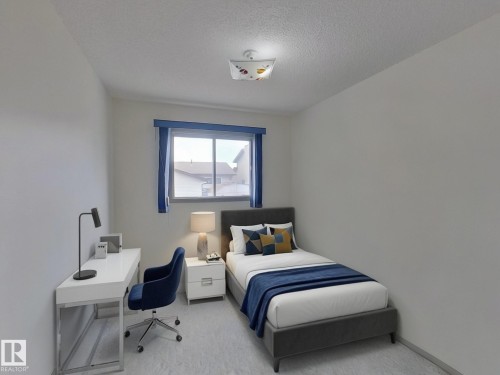 This room features a window with blue trim, light-colored walls, and a ceiling light fixture - 14523 32 Street, Edmonton, AB - Indoor Photo Showing Bedroom
