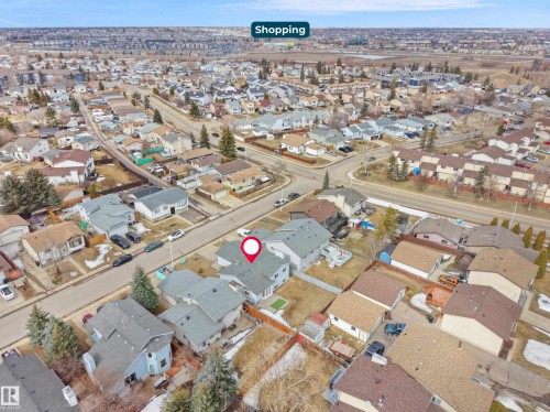 Aerial view of the property and its surrounding neighborhood, showcasing residential streets, detached houses, and a nearby commercial area indicated by a "Shopping" label - 14523 32 Street, Edmonton, AB -  With View