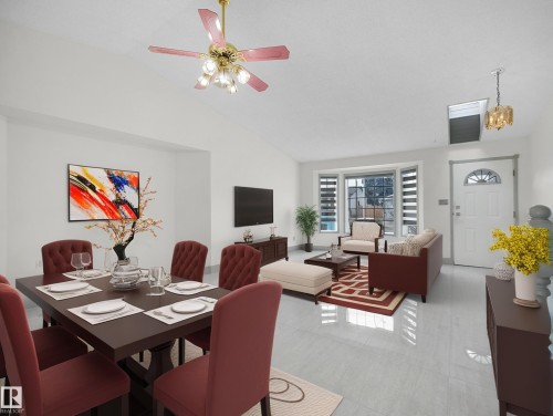 The open concept living and dining area features light-colored flooring, a bay window, and a ceiling fan - 14523 32 Street, Edmonton, AB - Indoor
